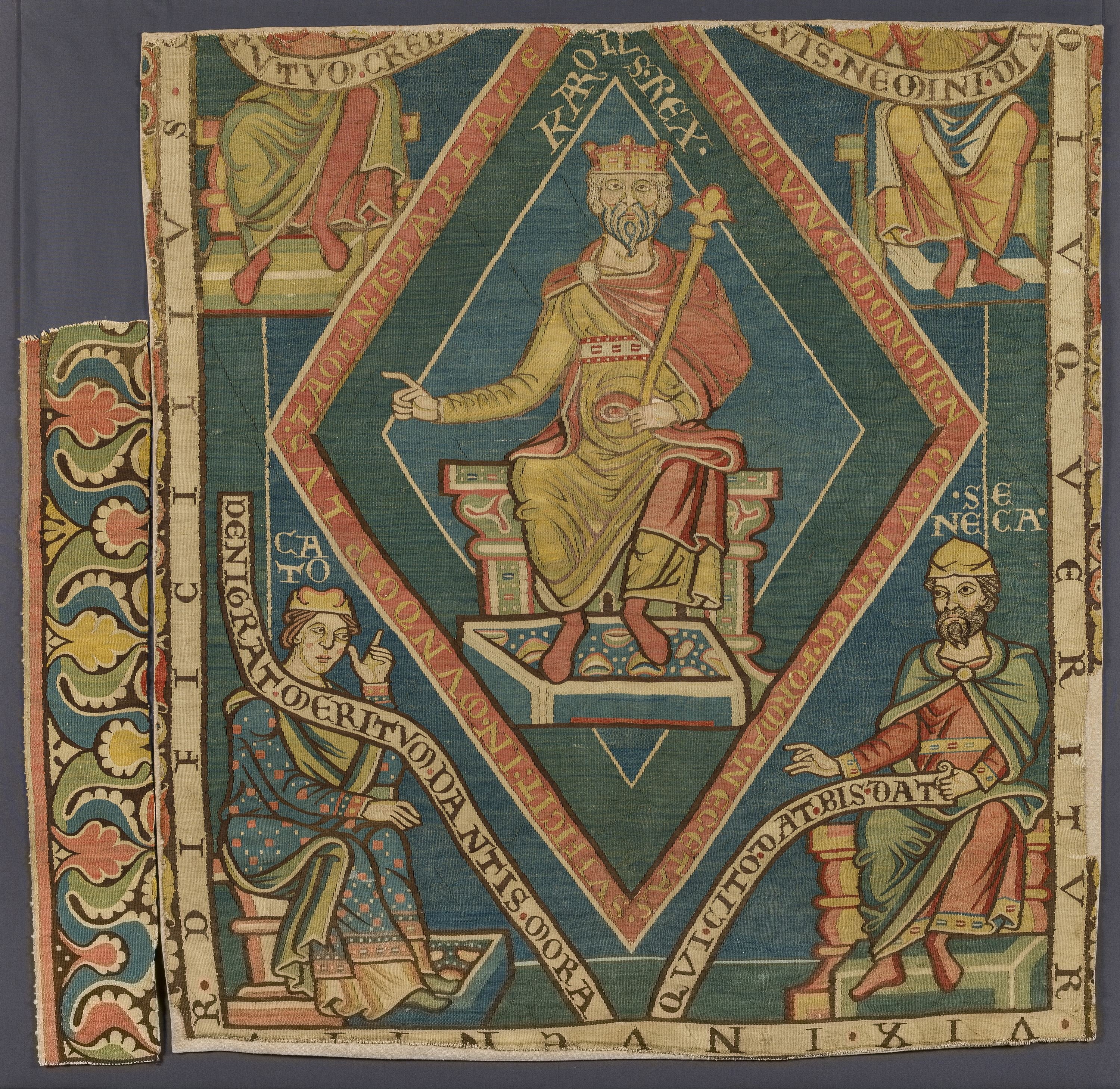 Tapestry in colour with Charlemagne sitting on a throne, surrounded by scribes and/or philosophers.