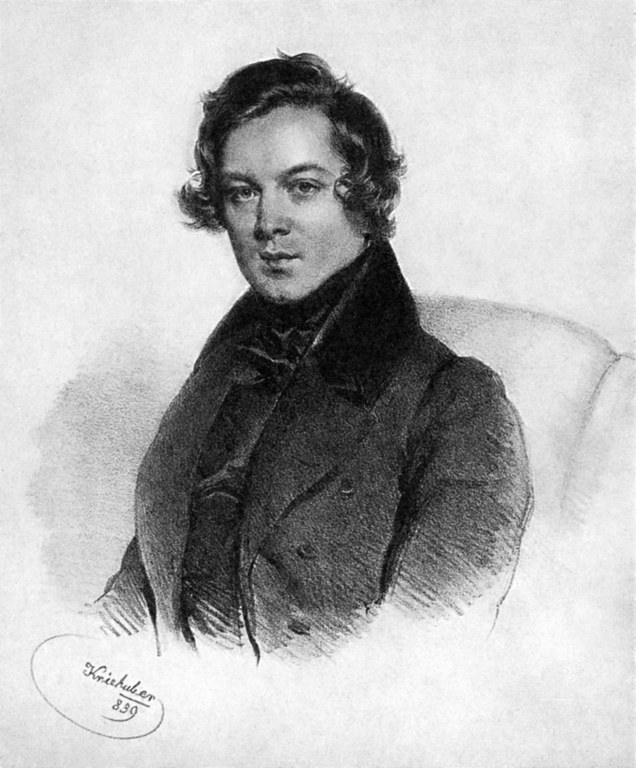 Black and white drawing with 29 year old Robert Schumann sitting in a chair. He wears a dark coat with a high collar. On the left bottom there is Kriehuber's signature.